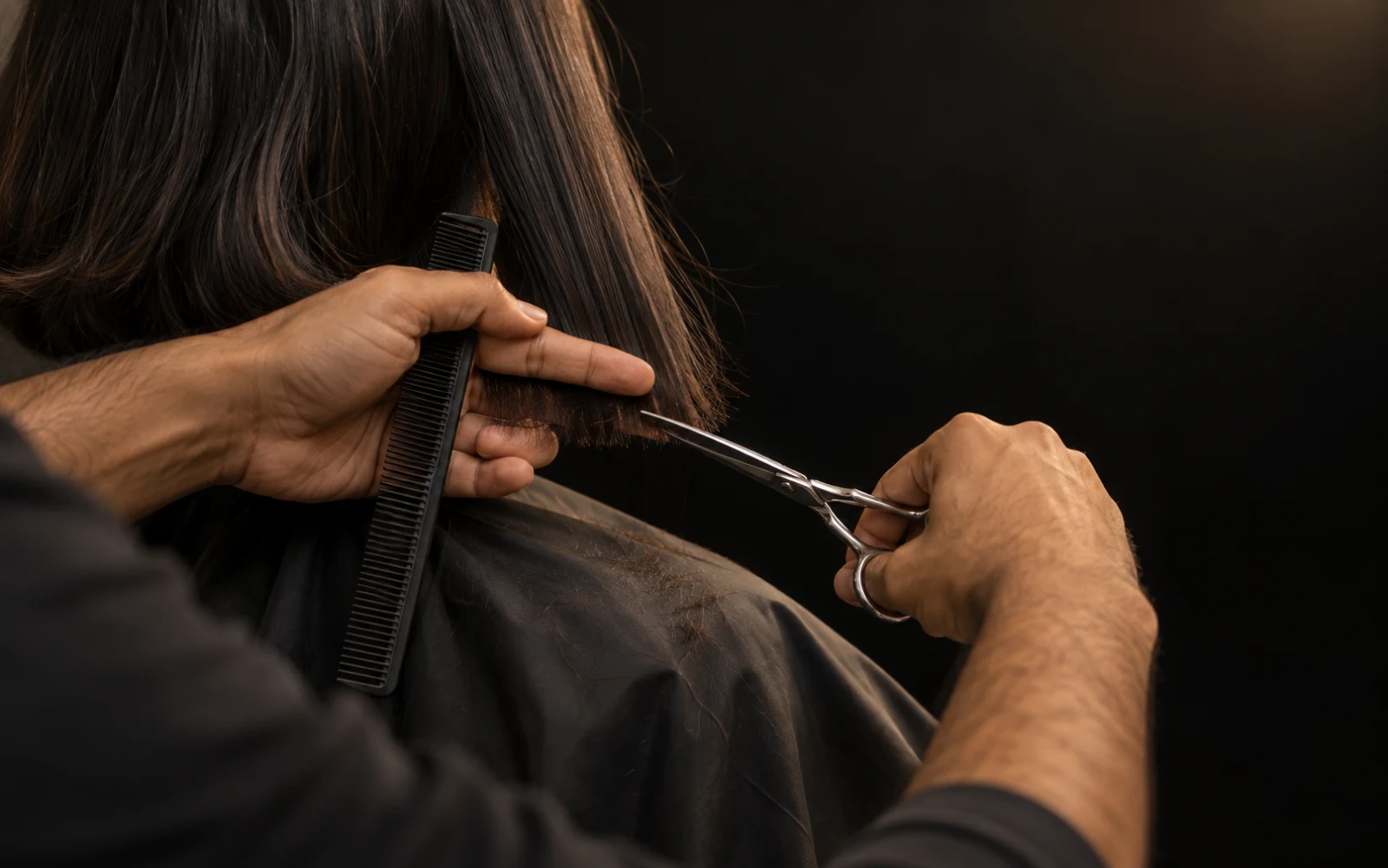 Salon artist refining a precise haircut with comb and scissors